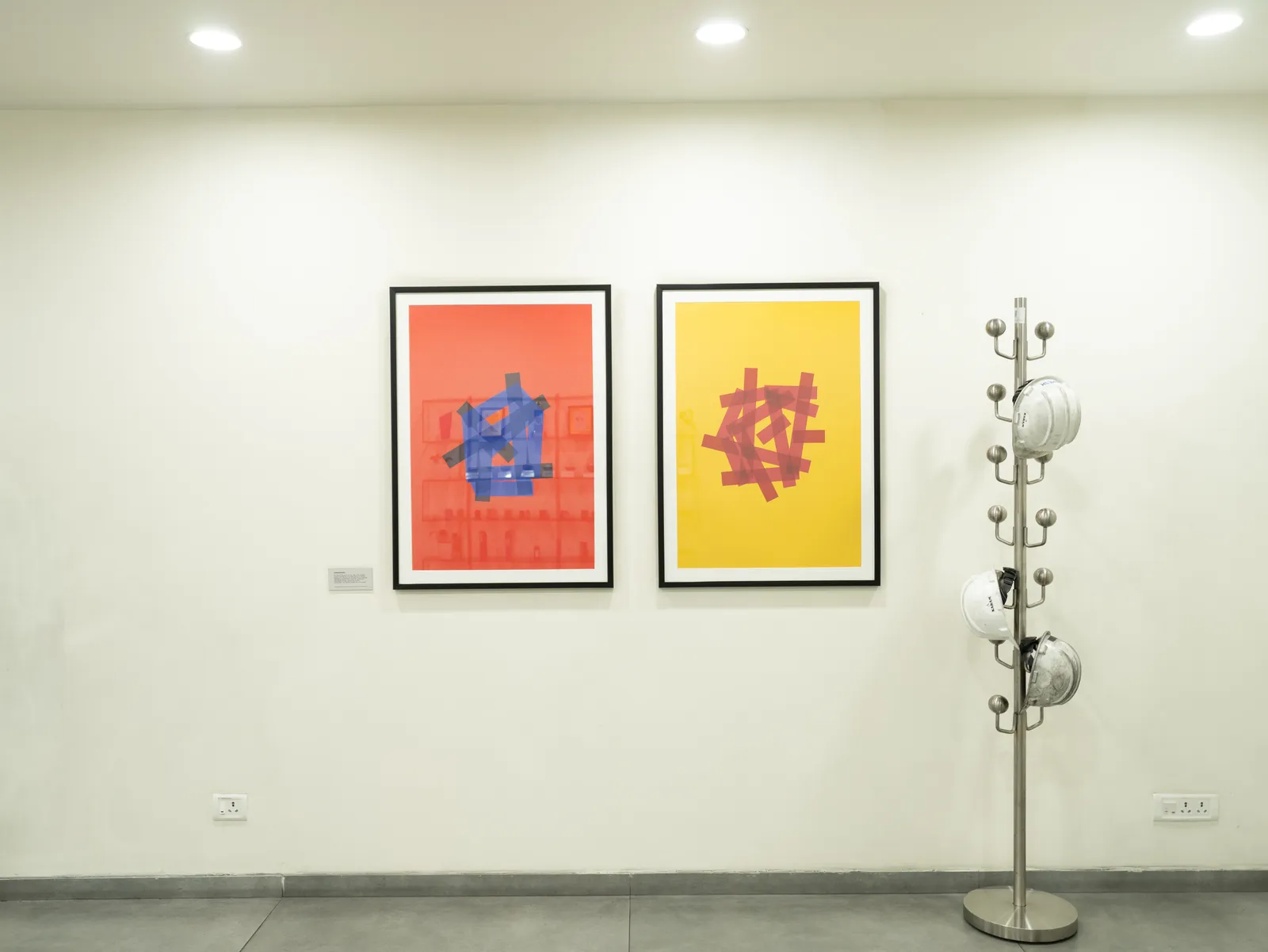 Office wall with colourful framed prints — LICO